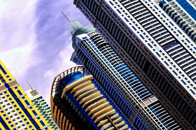 Low angle view of modern buildings in city against sky