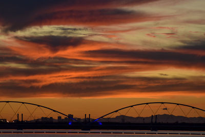 Low angle view of bridge against sky during sunset