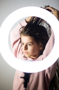 Girl 7 years old with long hair and a round lamp