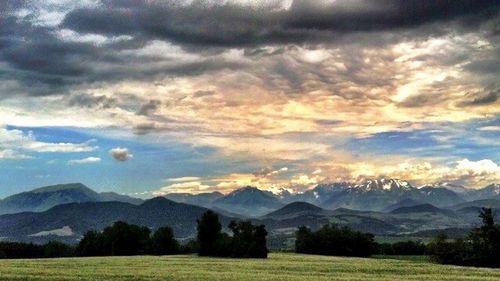 Scenic view of mountains against cloudy sky