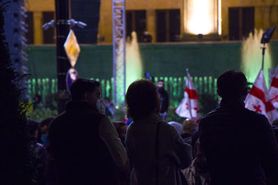 Rear view of people enjoying at music concert