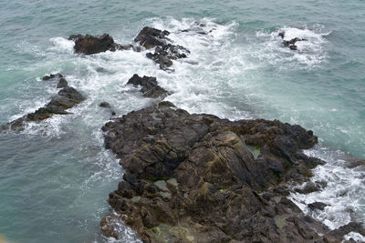 High angle view of rocks in sea