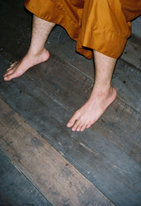 Low section of man on hardwood floor