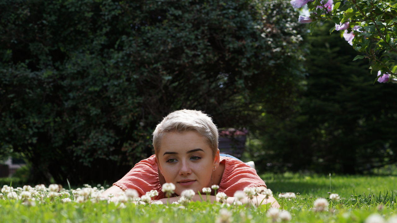 plant, portrait, leisure activity, real people, child, one person, front view, grass, field, nature, day, lifestyles, looking at camera, headshot, girls, land, childhood, outdoors, teenager