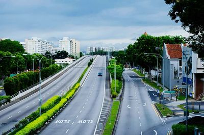 Road by city against sky