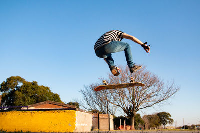 Portrait of skateboarder jumping