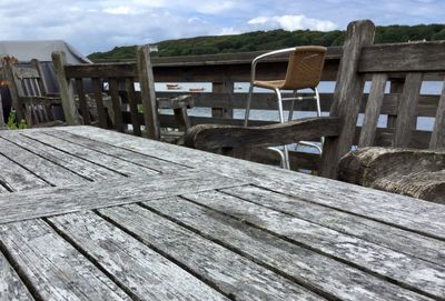 Wooden structure on beach against sky