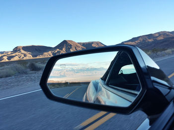 High angle view of road and mountains against blue sky