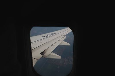 Close-up of airplane wing seen through window