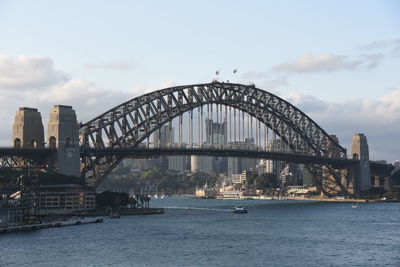 View of bridge over river against cloudy sky