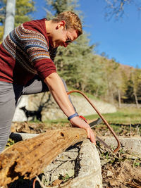 Side view of man working on field