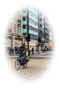 Man riding bicycle on city street