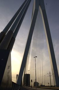 Low angle view of bridge against cloudy sky