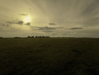 Scenic view of field against sky during sunset