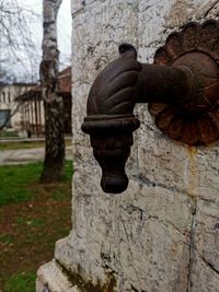 Close-up of old statue against building