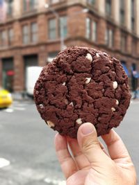 Close-up of hand holding a huge cookie 