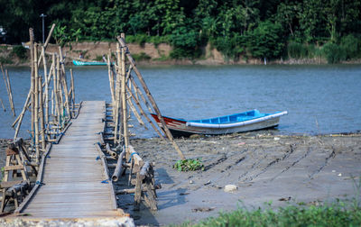 Boats moored at riverbank