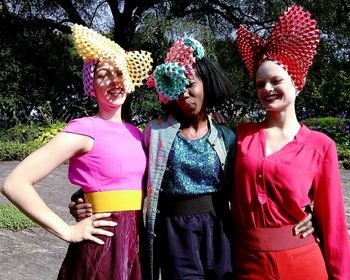 Portrait of smiling young women standing outdoors