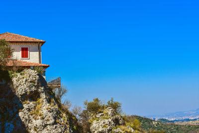 Low angle view of building against clear blue sky