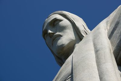 Low angle view of statue against clear blue sky