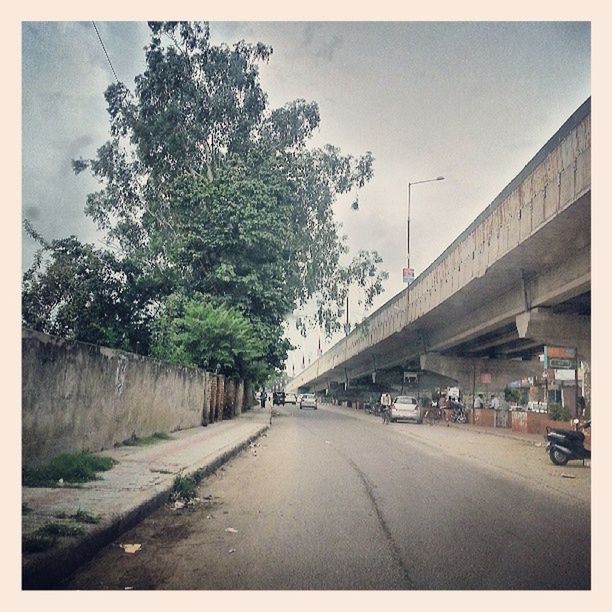 the way forward, transfer print, transportation, road, diminishing perspective, vanishing point, architecture, street, road marking, built structure, sky, auto post production filter, building exterior, tree, empty, long, car, day, clear sky, outdoors