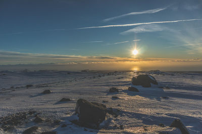 Scenic view of frozen lake against sky during winter