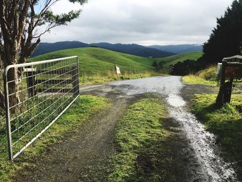 Scenic view of landscape against cloudy sky