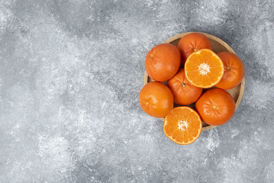 High angle view of orange fruit against white background