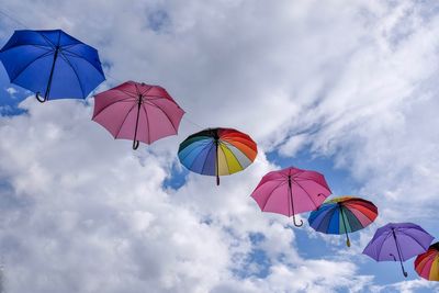 Low angle view of umbrellas against sky