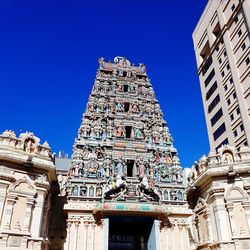 Low angle view of statue against blue sky