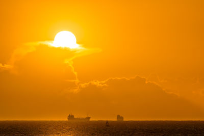 Scenic view of sea against orange sky