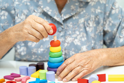 Midsection of man holding toy