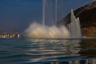 Panoramic view of fountain in sea against sky