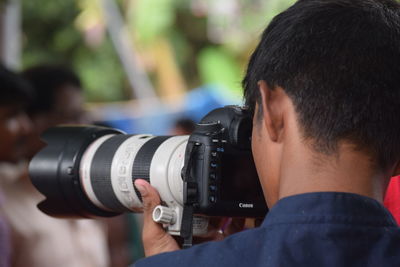 Rear view of man photographing