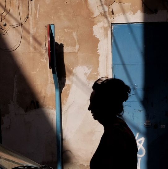 indoors, lifestyles, wall - building feature, window, architecture, built structure, leisure activity, standing, men, person, wall, rear view, messy, graffiti, glass - material, side view, day, shadow