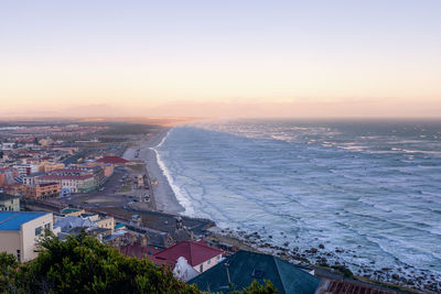 High angle view of buildings by sea against sky