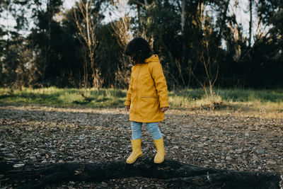 Child climbing a tree trunk