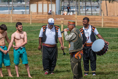 Full length of men playing on field