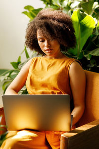 Midsection of woman using mobile phone