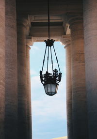 Low angle view of men hanging against sky