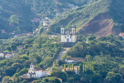 High angle view of trees and buildings in city