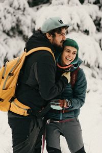 Young man and woman wearing hat during winter