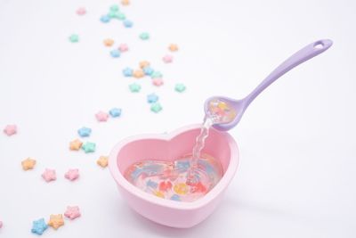 High angle view of multi colored candies on white background
