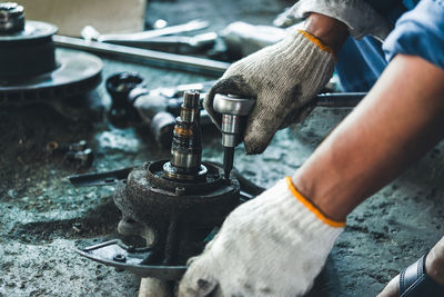 Cropped hand of man working at workshop