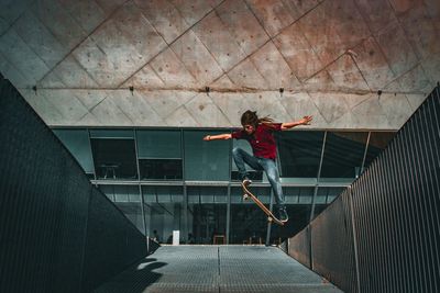 Full length of man performing stunt in skateboard park