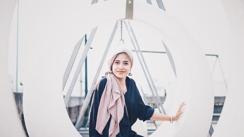 Portrait of beautiful woman standing against clear sky