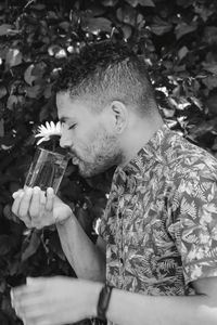 Young man drinking food outdoors