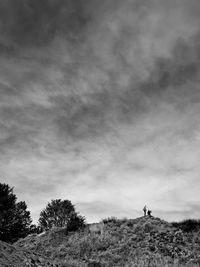 Scenic view of landscape against cloudy sky