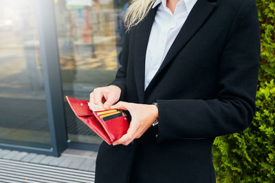 Midsection of woman holding umbrella