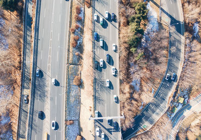 A cars drive along loop shaped road junction top view.